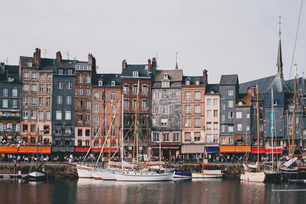 Historic buildings and yachts in the picturesque Honfleur harbor.