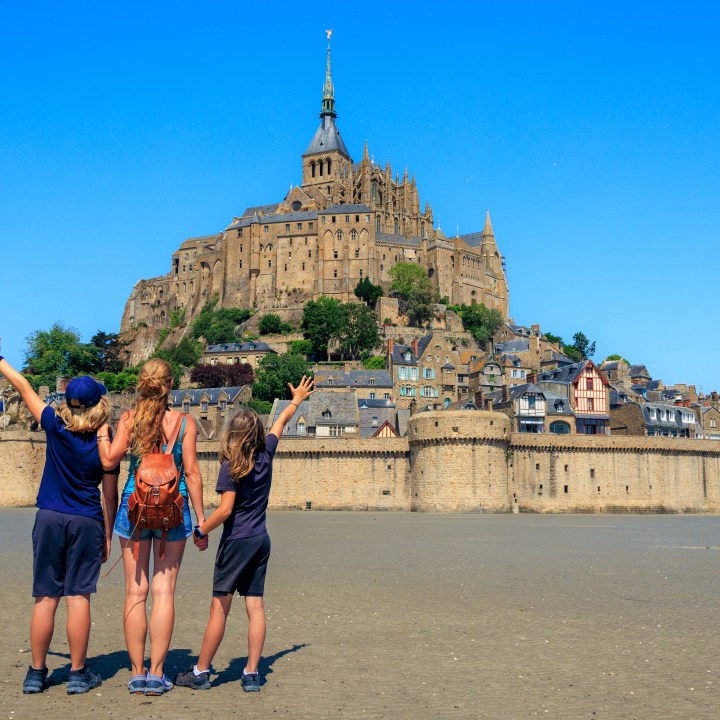 Family traveling in France- famous touristic of Le Mont Saint Michel - Normandy
